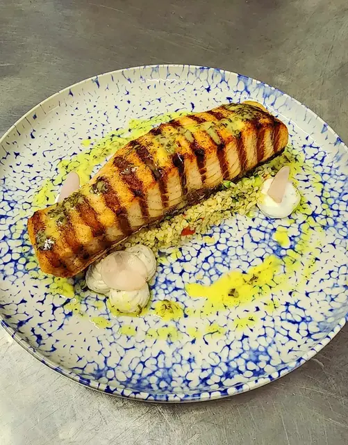 Grilled salmon on a blue and white plate