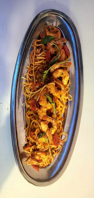 Spaghetti in a rich sauce served in an oval dish