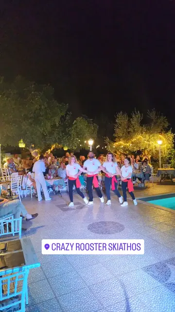 Dancers in traditional costume performing by the pool