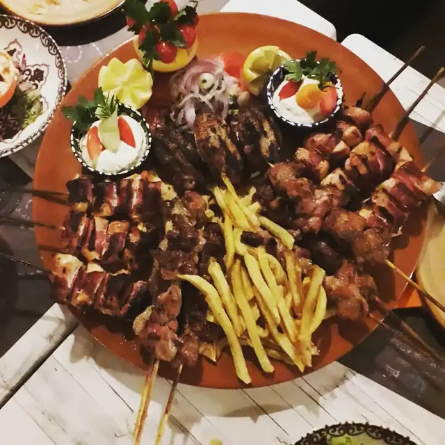 Mixed grill platter of skewers, grilled meat and fries