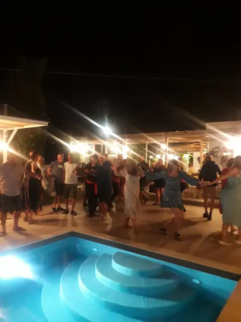 Dancing round the lit pool on an event night