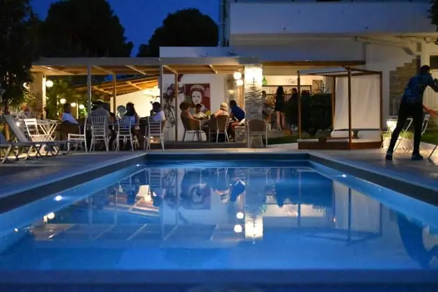 The pool and the restaurant lit up at dusk